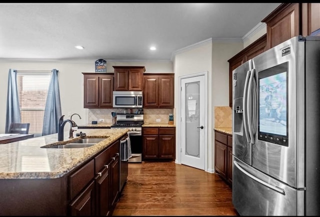 7012 Perot Ranch Rd, Odessa, TX 79765 - kitchen with appliances with stainless steel finishes, a sink, crown molding, dark wood-style flooring, and decorative backsplash