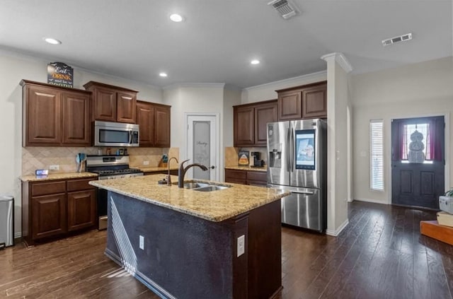 7012 Perot Ranch Rd, Odessa, TX 79765 - kitchen with stainless steel appliances, a sink, an island with sink, light stone countertops, and dark wood-type flooring