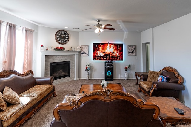 carpeted living room with a brick fireplace and ceiling fan