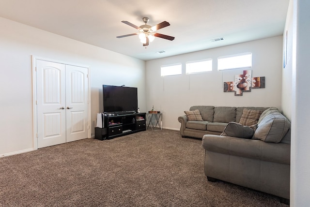 carpeted living room with ceiling fan