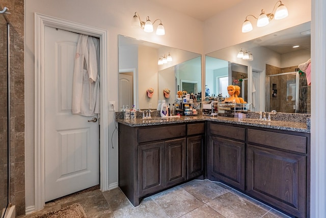 bathroom with a shower with door and vanity