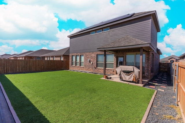 back of house with a yard and a patio area