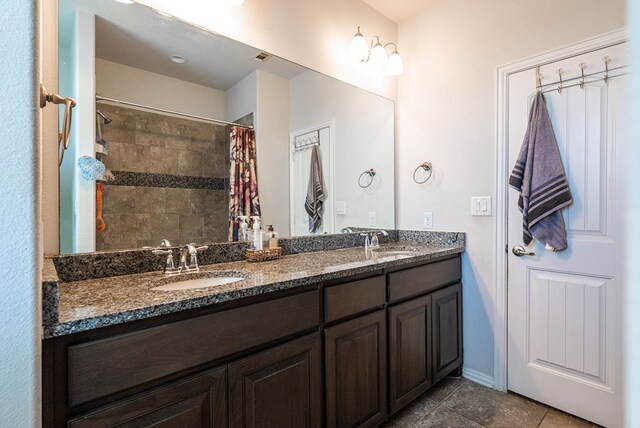 bathroom featuring vanity, curtained shower, and tile patterned floors