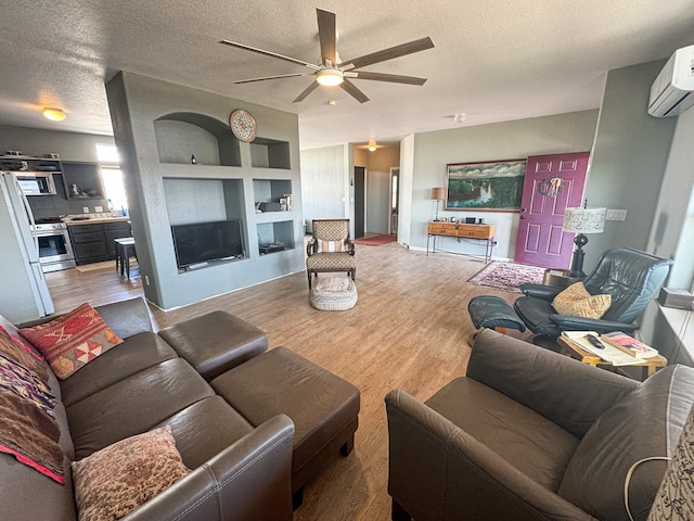 1500 Rancho Rd, Presidio, TX 79845 - living room featuring a wall mounted AC, ceiling fan, a textured ceiling, wood finished floors, and built in features