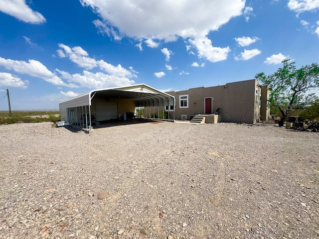 1500 Rancho Rd, Presidio, TX 79845 - rear view of house featuring a detached garage and stucco siding