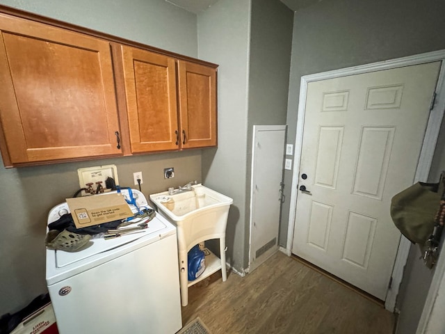 1500 Rancho Rd, Presidio, TX 79845 - washroom with dark wood-type flooring, cabinet space, and washer / dryer