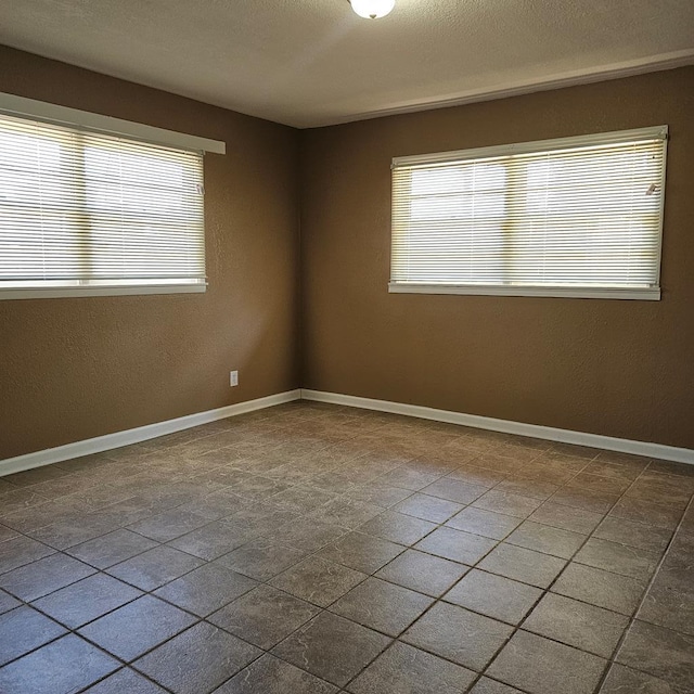 801 W Golf Course Rd, Midland, TX 79701 - spare room featuring baseboards