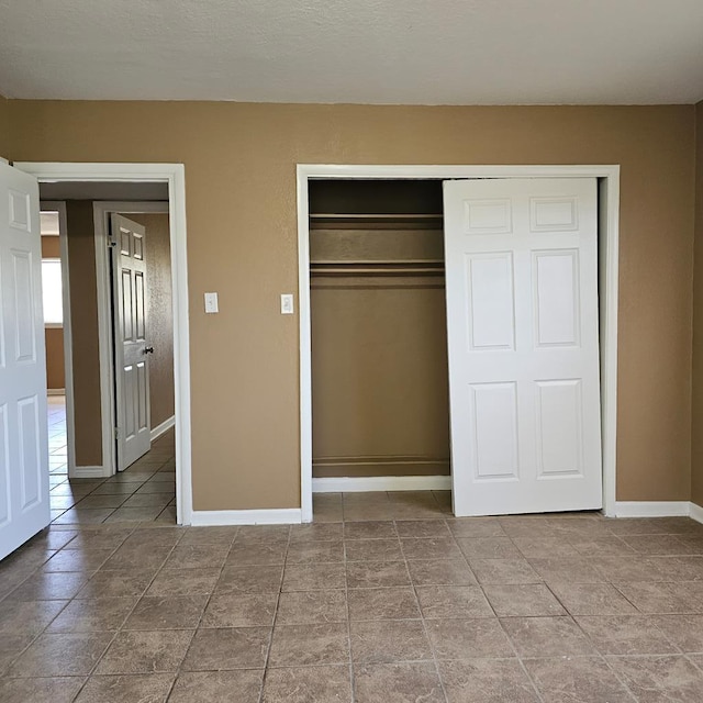 801 W Golf Course Rd, Midland, TX 79701 - unfurnished bedroom featuring baseboards and a closet