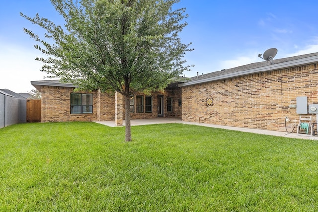 back of property featuring a patio area and brick siding