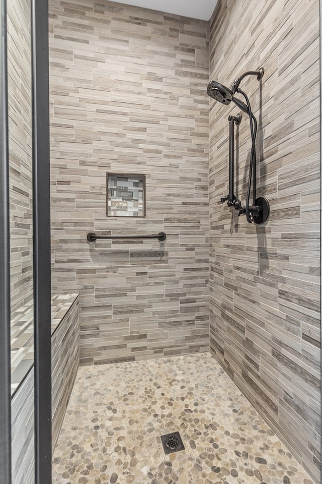 bathroom with a tile shower