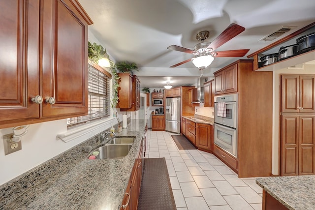 104 E 3rd St, Marfa, TX 79843 - kitchen with visible vents, light tile patterned flooring, stainless steel refrigerator with ice dispenser, multiple ovens, and a sink