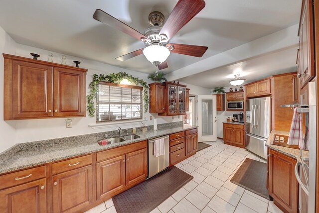 104 E 3rd St, Marfa, TX 79843 - kitchen with brown cabinets, stainless steel appliances, light tile patterned flooring, and a sink