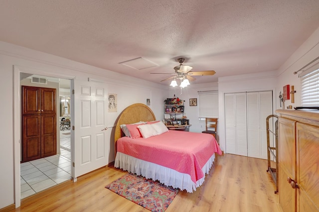 104 E 3rd St, Marfa, TX 79843 - bedroom featuring attic access, a textured ceiling, visible vents, a closet, and light wood finished floors