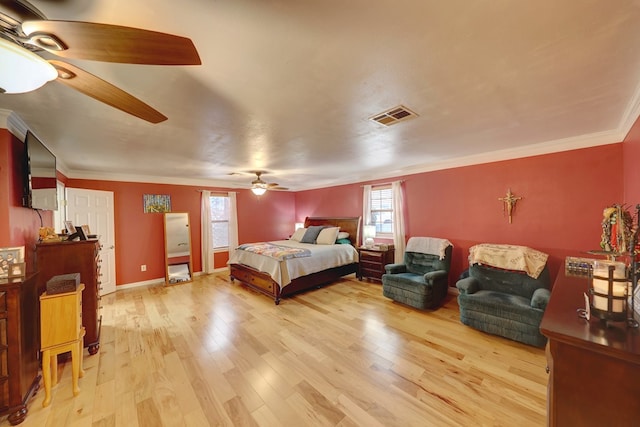 104 E 3rd St, Marfa, TX 79843 - bedroom with multiple windows, ornamental molding, wood finished floors, and visible vents