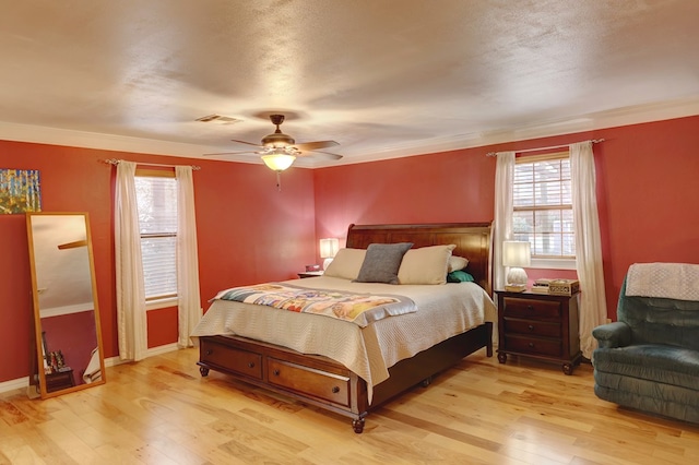 104 E 3rd St, Marfa, TX 79843 - bedroom featuring light wood-type flooring, a ceiling fan, visible vents, and ornamental molding