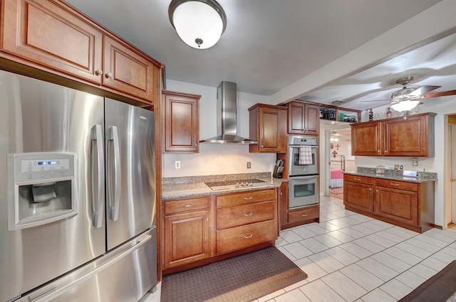 104 E 3rd St, Marfa, TX 79843 - kitchen featuring brown cabinets, appliances with stainless steel finishes, light stone counters, wall chimney exhaust hood, and a ceiling fan