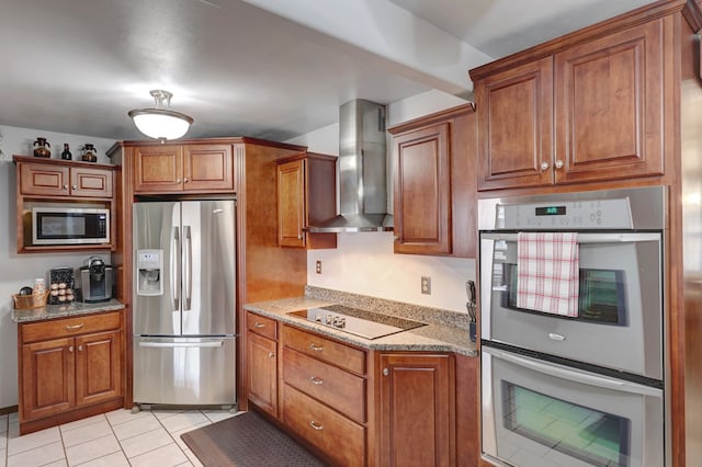 104 E 3rd St, Marfa, TX 79843 - kitchen featuring wall chimney exhaust hood, appliances with stainless steel finishes, and brown cabinets