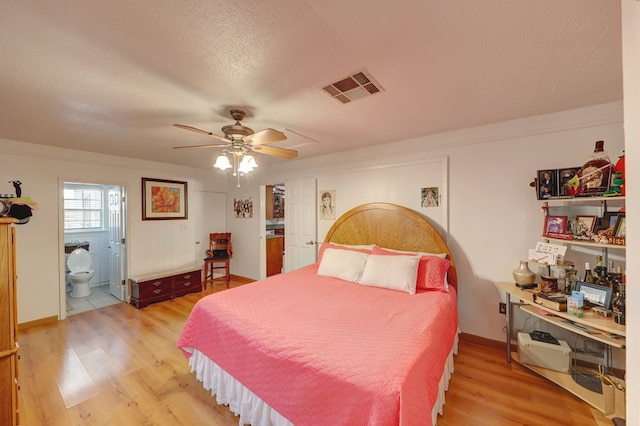 104 E 3rd St, Marfa, TX 79843 - bedroom featuring visible vents, ceiling fan, connected bathroom, a textured ceiling, and light wood finished floors