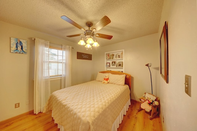 104 E 3rd St, Marfa, TX 79843 - bedroom with a textured ceiling, light wood-style flooring, and a ceiling fan