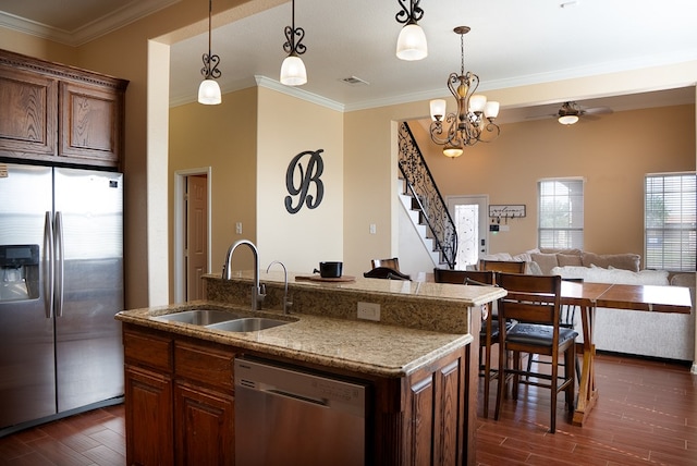 9540 W April St, Odessa, TX 79764 - kitchen with stainless steel appliances, dark wood finished floors, open floor plan, a center island with sink, and pendant lighting