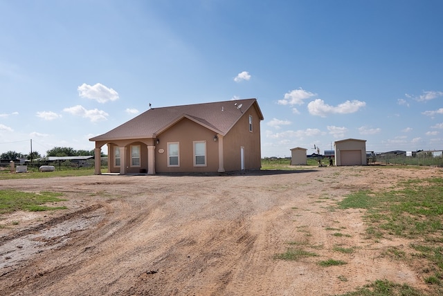 9540 W April St, Odessa, TX 79764 - view of front of house with driveway, a detached garage, and stucco siding