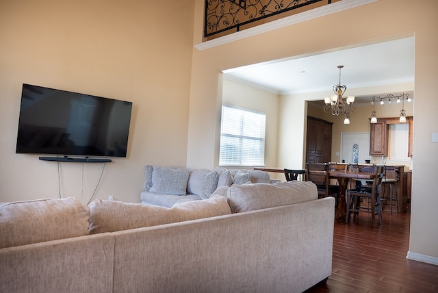 9540 W April St, Odessa, TX 79764 - living area with a chandelier, crown molding, and dark wood-style floors