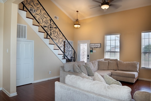 9540 W April St, Odessa, TX 79764 - living room featuring ornamental molding, a ceiling fan, dark wood-type flooring, stairway, and a towering ceiling