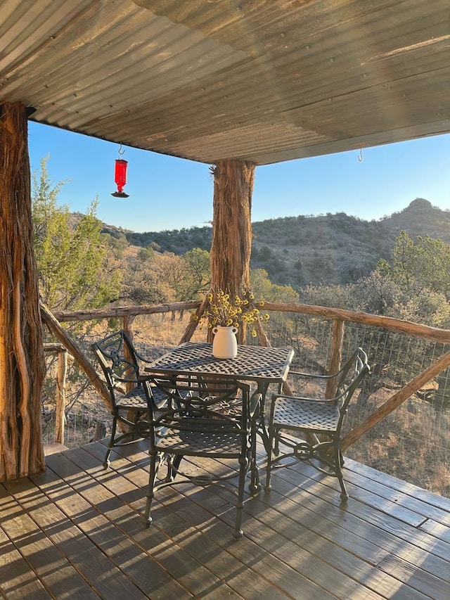 deck featuring a wooded view and a mountain view