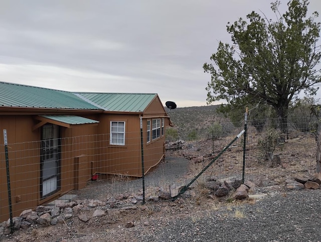 view of side of home featuring metal roof