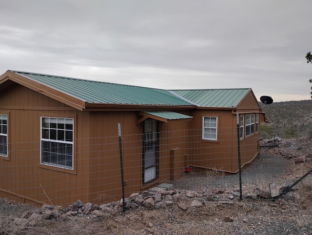 view of side of property featuring metal roof