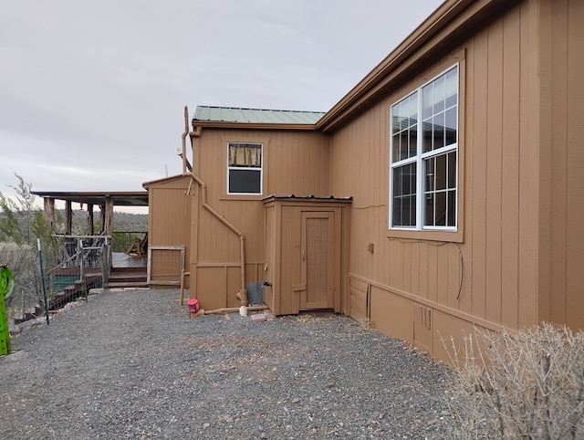 view of side of property with a deck, metal roof, and crawl space