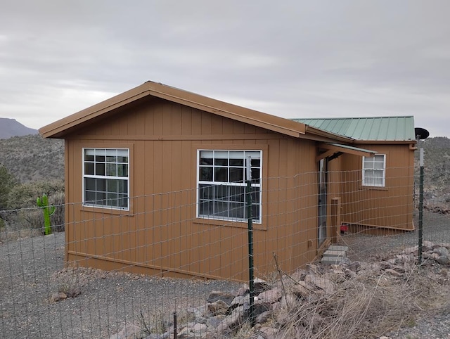 view of side of home featuring metal roof