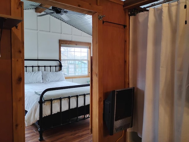 bedroom featuring vaulted ceiling with beams and wood finished floors