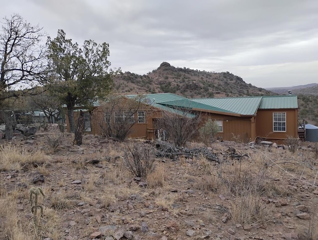 exterior space with metal roof and a mountain view