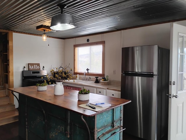 kitchen featuring appliances with stainless steel finishes, butcher block counters, and a sink