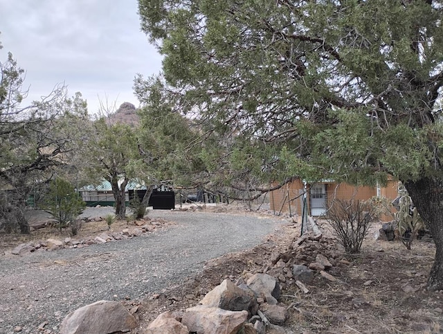 view of road with gravel driveway