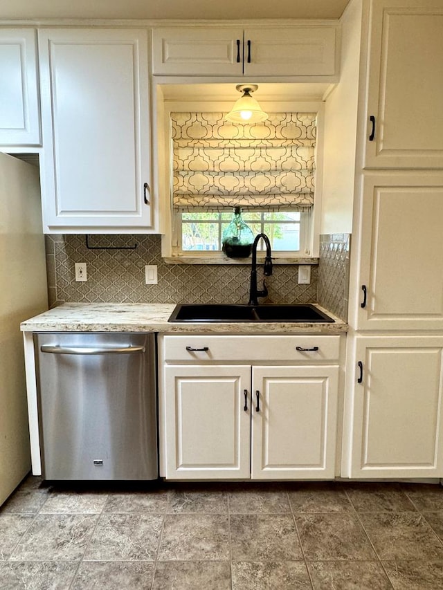2003 N Enfield Rd, Alpine, TX 79830 - kitchen with stainless steel dishwasher, a sink, white cabinets, and tasteful backsplash