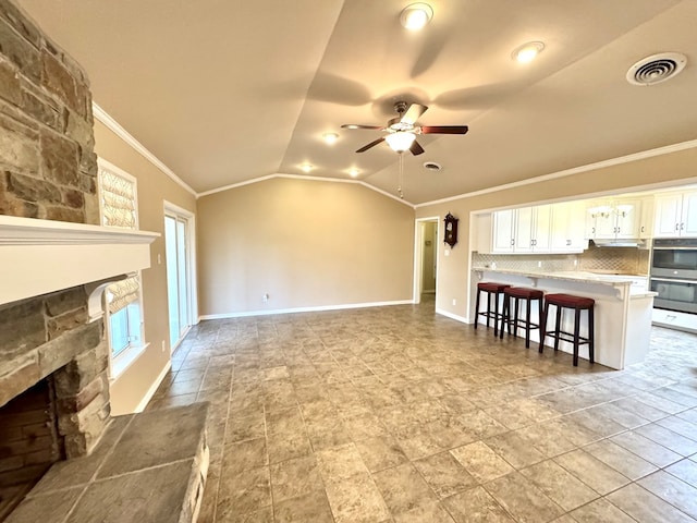 2003 N Enfield Rd, Alpine, TX 79830 - unfurnished living room featuring a fireplace, ornamental molding, ceiling fan, lofted ceiling, and baseboards