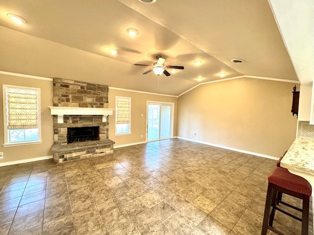2003 N Enfield Rd, Alpine, TX 79830 - unfurnished living room with vaulted ceiling, ceiling fan, baseboards, crown molding, and a stone fireplace