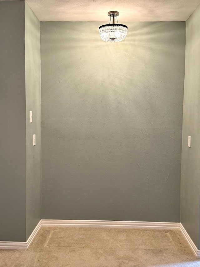 2003 N Enfield Rd, Alpine, TX 79830 - unfurnished room featuring carpet, baseboards, and a textured ceiling