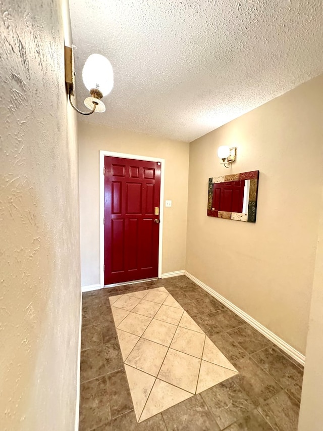 2003 N Enfield Rd, Alpine, TX 79830 - foyer entrance featuring light tile patterned floors, a textured ceiling, and baseboards