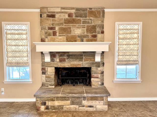 2003 N Enfield Rd, Alpine, TX 79830 - detailed view of baseboards, crown molding, and a stone fireplace