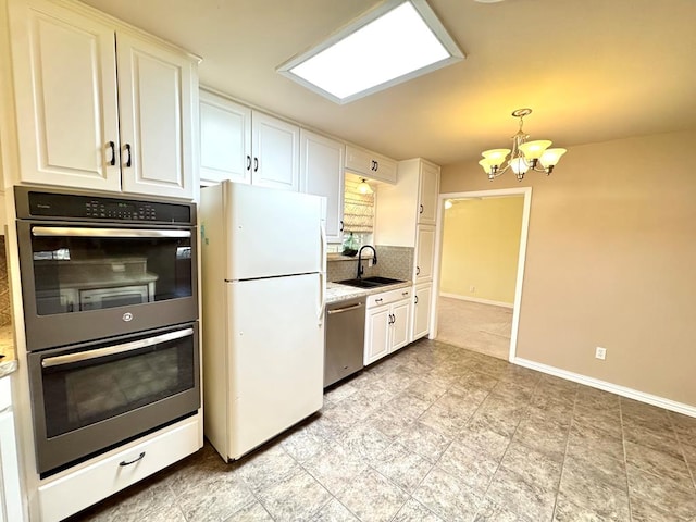 2003 N Enfield Rd, Alpine, TX 79830 - kitchen featuring stainless steel appliances, a sink, a chandelier, white cabinets, and baseboards