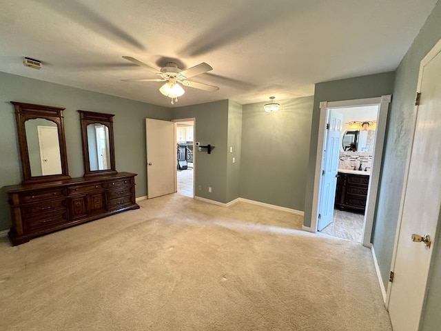 2003 N Enfield Rd, Alpine, TX 79830 - unfurnished bedroom featuring light colored carpet, baseboards, ensuite bathroom, and ceiling fan