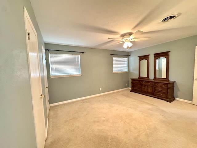 2003 N Enfield Rd, Alpine, TX 79830 - unfurnished bedroom with light colored carpet, baseboards, and ceiling fan