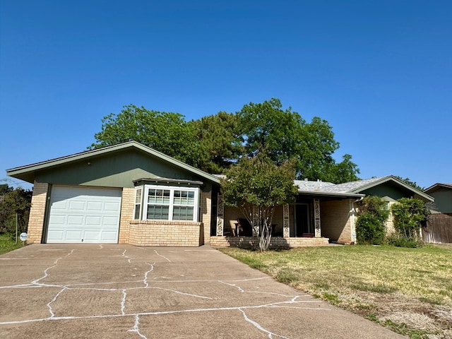 2003 N Enfield Rd, Alpine, TX 79830 - ranch-style house featuring brick siding, a front lawn, driveway, an attached garage, and a porch