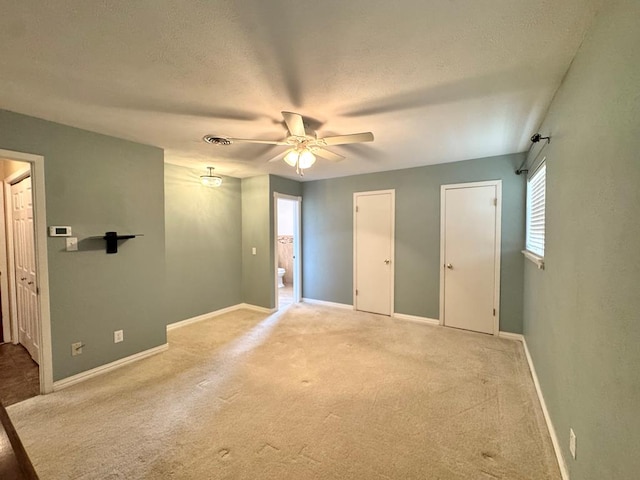 2003 N Enfield Rd, Alpine, TX 79830 - unfurnished bedroom featuring multiple windows, carpet, baseboards, and a textured ceiling