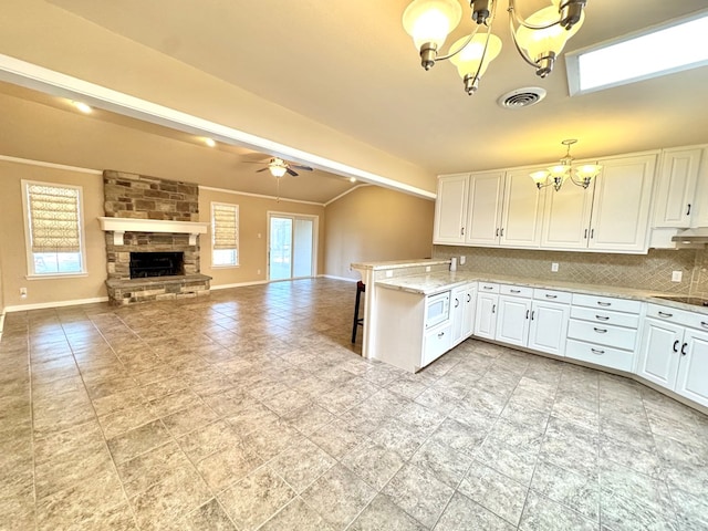 2003 N Enfield Rd, Alpine, TX 79830 - kitchen with a chandelier, tasteful backsplash, and white cabinetry