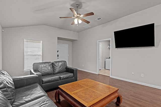living area with visible vents, a ceiling fan, baseboards, and wood finished floors