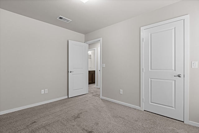 unfurnished bedroom with baseboards, carpet flooring, and visible vents